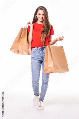 Portrait of young happy smiling woman with shopping bags over white background