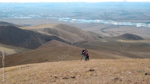 Young Woman Hiker is Traveling with her Child Daughter in Mountains. Amzaing Landscape View is on the Background. Adventure Recreation Vacations, Travel Lifestyle and People Concept photo