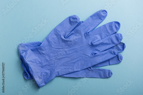 Latex gloves on blue background. Personal Protective Equipment. © lafabricadestock