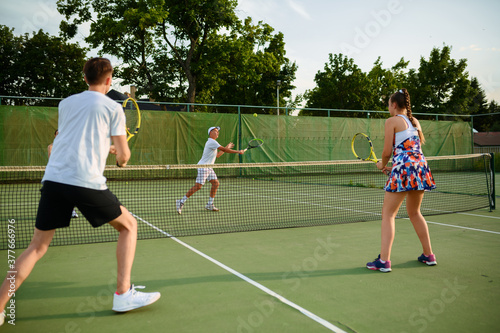 Mixed doubles tennis players, outdoor court