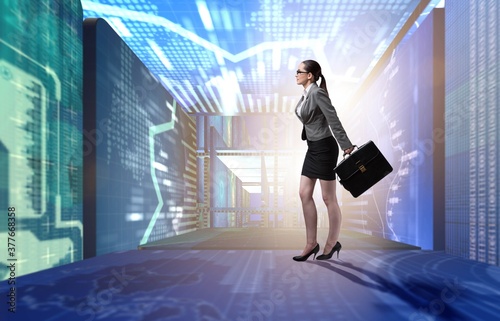 Businesswoman walking in data management concept © Elnur