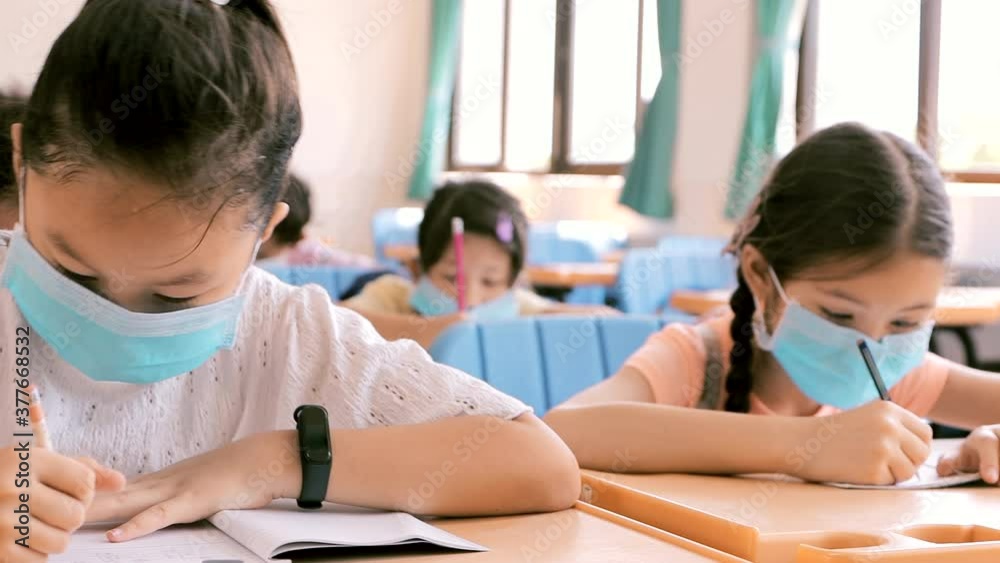 
students wearing  mask and  studying in the classroom