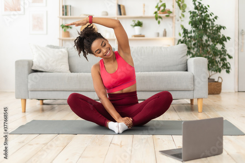 Black Girl Exercising At Laptop Having Online Training At Home