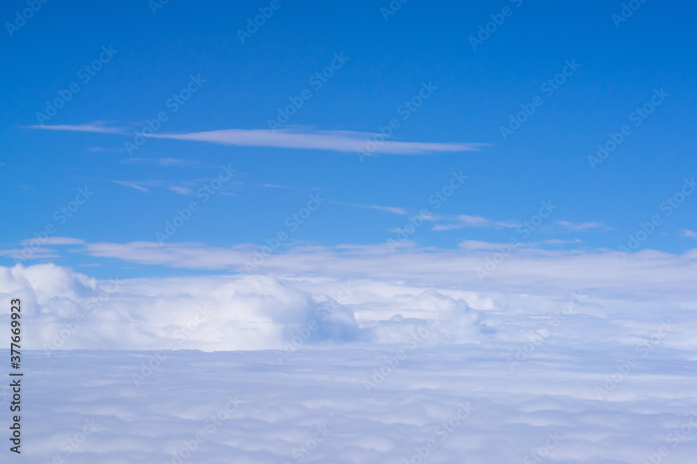 Aerial view of cloudscape seen through airplane window