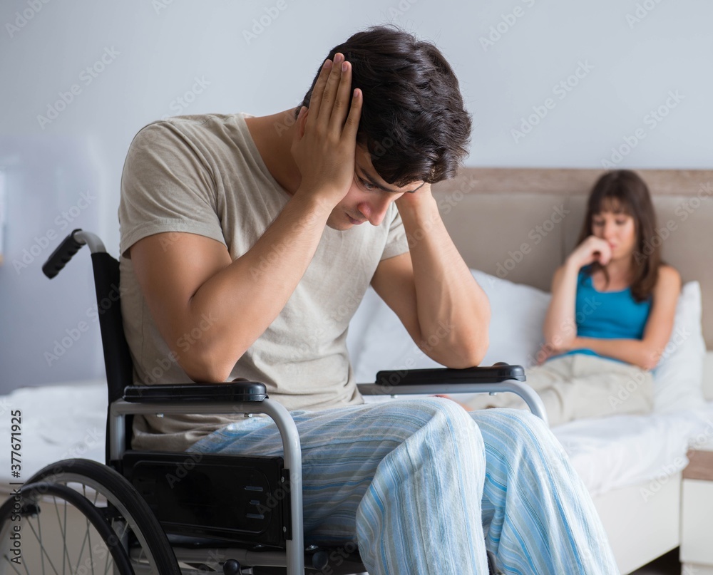 Desperate man on wheelchair with his sad wife