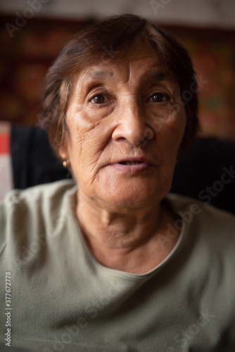 Close-up portrait of an elderly dark-haired woman ..