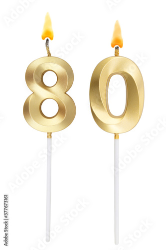 Burning golden birthday candles isolated on white background, number 80 photo