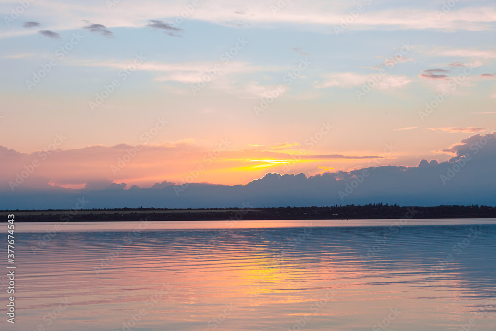 colored sunset over the river, with sky reflection colored sunset over the river, with sky reflection
