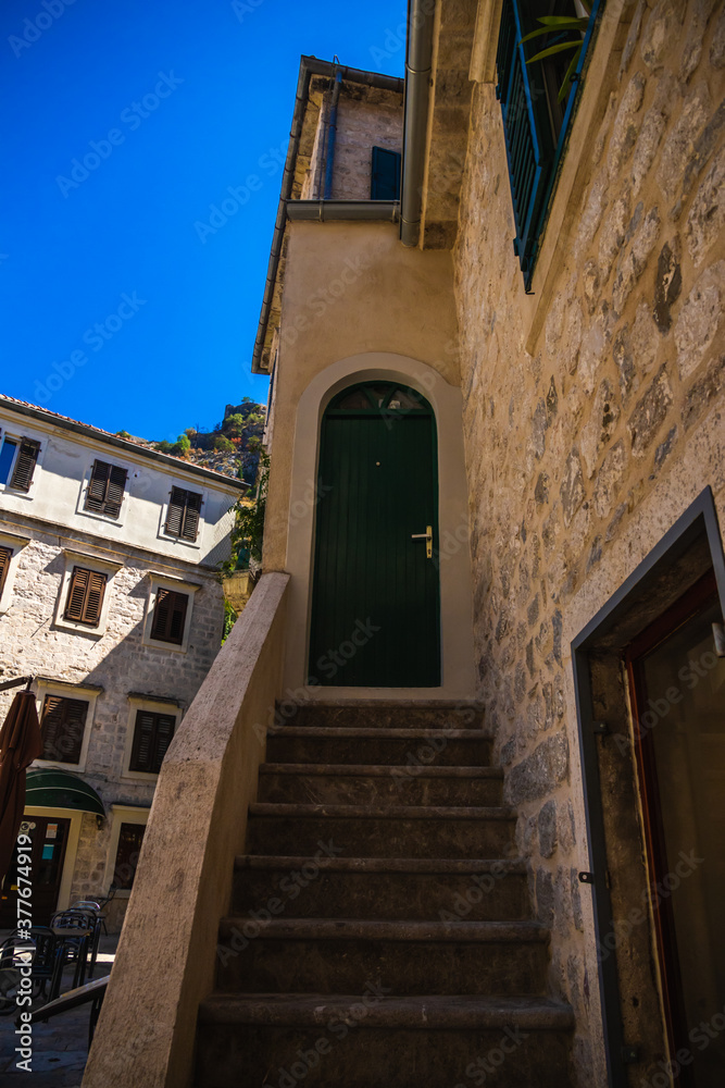 Lonely door with stairs, architecture of the old town of Kotor