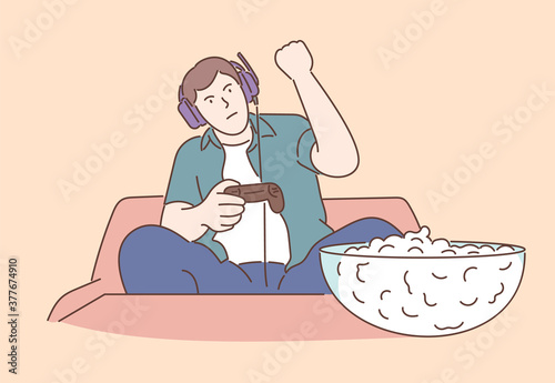 Home rest, playing games concept. Resting at home. Handsome young man playing video games.