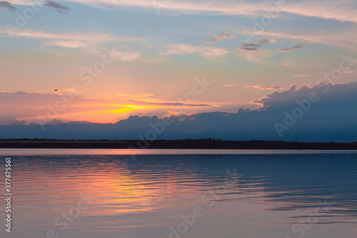 colored sunset over the river  with sky reflection