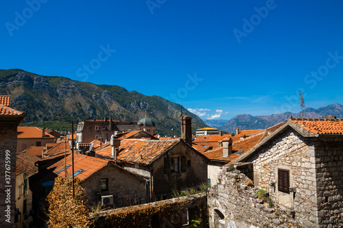 View of the old European city of Kotor, red tiled roofs and the Adriatic sea coast with mountains
