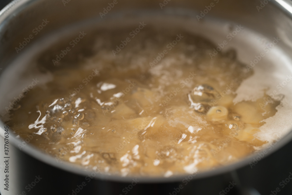 Cooking fusilli in boiling water closeup Cooking fusilli in boiling water closeup