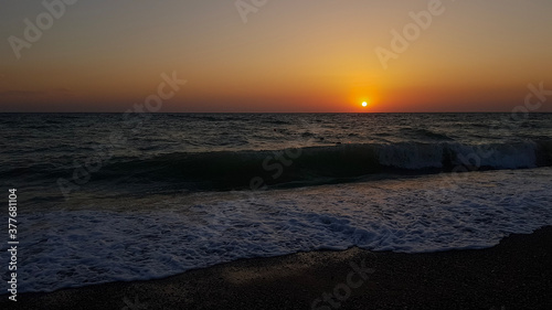 Beautiful sunset beach bright background with setting down sun in horizon