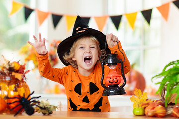 Child in Halloween costume. Kids trick or treat.
