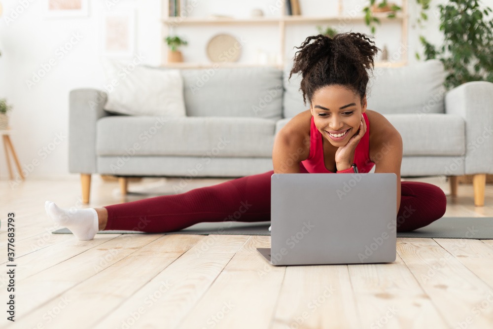 Fit Black Woman Exercising Stretching At Laptop Computer At Home Fit Black Woman Exercising Stretching At Laptop Computer At Home