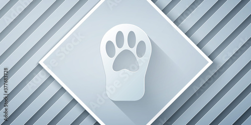 Paper cut Paw print icon isolated on grey background. Dog or cat paw print. Animal track. Paper art style. Vector.