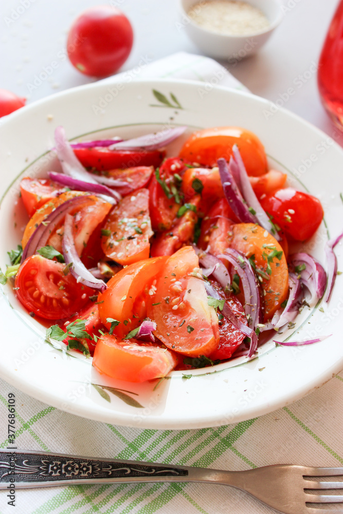 Sliced tomatoes with red onion, spices in oil Sliced tomatoes with red onion, spices in oil