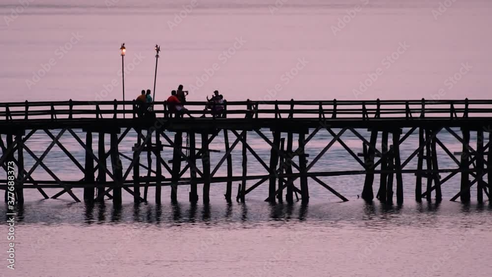 The Mon Bridge is an old wooden bridge located in Sangkla, Thailand. Monks and people cross before sunrise to earn merits and take blessings; in the afternoon, a leisure place to meet friends.
