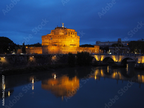 Night view of the angel's castle, the Tiber river and the bridge over it. Rome, Italy.