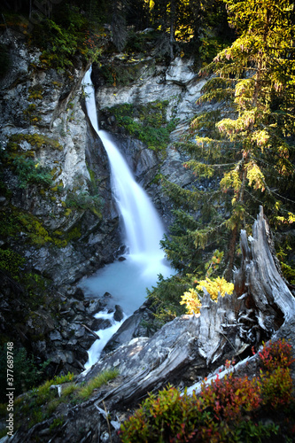 The Rutor waterfall, in Valle d'Aosta, descends impetuously among the rocks photo