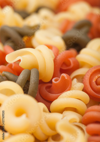 Raw homemade tricolore trottole pasta close up. photo