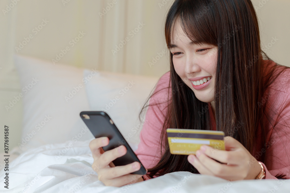 Young Asian woman holding credit card Young Asian woman holding credit card