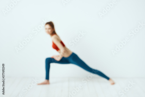 Sportive woman pose gymnastics balance exercise light background