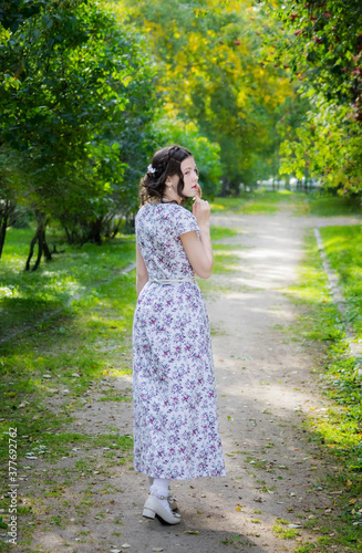 Young sad women in a park on a warm autumn day.