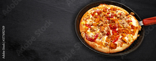 Traditional of hot cheese pizza on pan in the restaurant. View from above. Space for text.