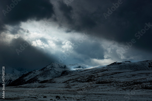 dramatic light on the snow capped mountains, kkh, khunjrab pass, gilgit baltistan , northern areas of Pakistan  photo