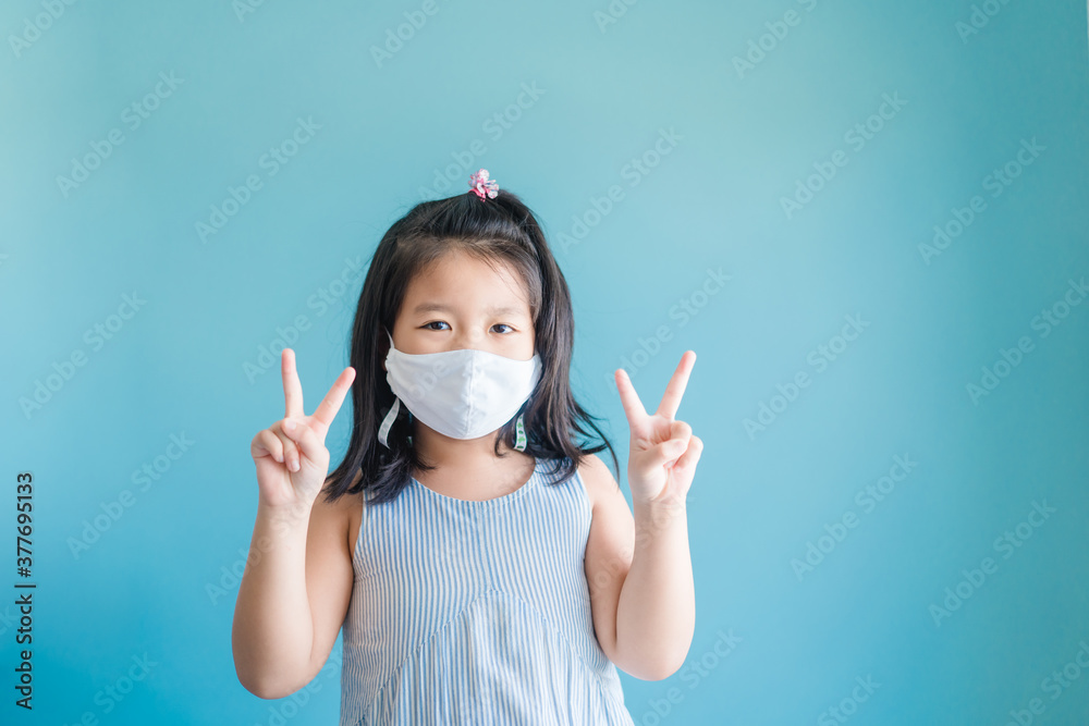 Coronavirus Covid-19.Online education at home.Asian kid girl wearing face mask show fight encourage to virus.Home school kid with Covid19. Online learning.Stay home.Social distancing.New normal. Coronavirus Covid-19.Online education at home.Asian kid girl wearing face mask show fight encourage to virus.Home school kid with Covid19. Online learning.Stay home.Social distancing.New normal.