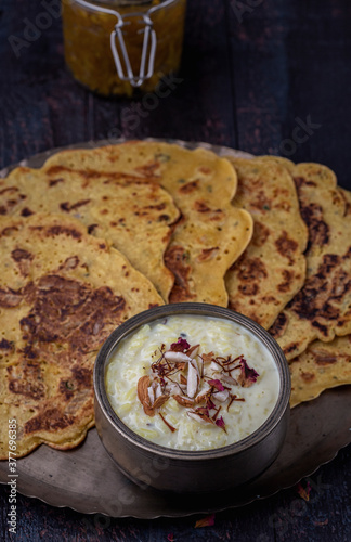 Kheer and besan puda, traditional punjabi foods served in traditional utensils photo