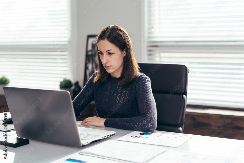 Woman sits at table and works with laptop. Freelance or online education. Woman sits at table and works with laptop. Freelance or online education.