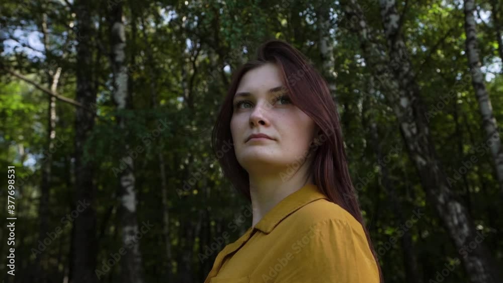 Woman bright yellow shirt stands forest park looks thoughtfully mysteriously delight over her shoulder back beauty nature. Hair grows day Traveling family to another city state. Unforgettable emotions Woman bright yellow shirt stands forest park looks thoughtfully mysteriously delight over her shoulder back beauty nature. Hair grows day Traveling family to another city state. Unforgettable emotions