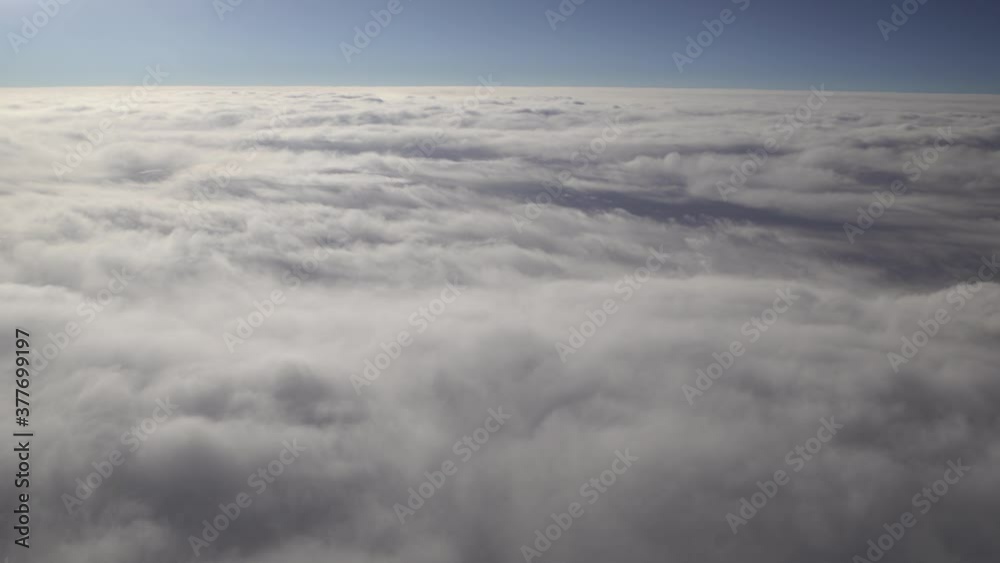 Flying plane and view from window at beautiful morning soft white clouds and blue sky Flying plane and view from window at beautiful morning soft white clouds and blue sky