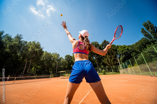Young athletic woman playing tennis on the court. © romaset