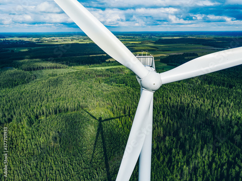 Aerial view of windmill close-up in green summer forest in Finland. Wind turbines for electric power  and Renewable Energy photo
