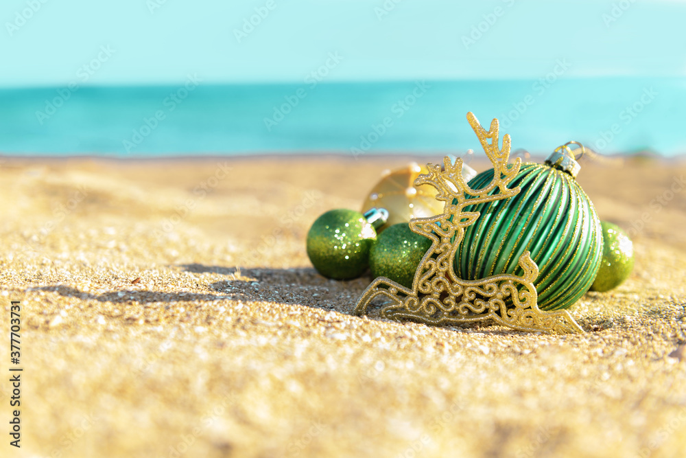 Christmas decoration green balls and gold reindeer on the tropical