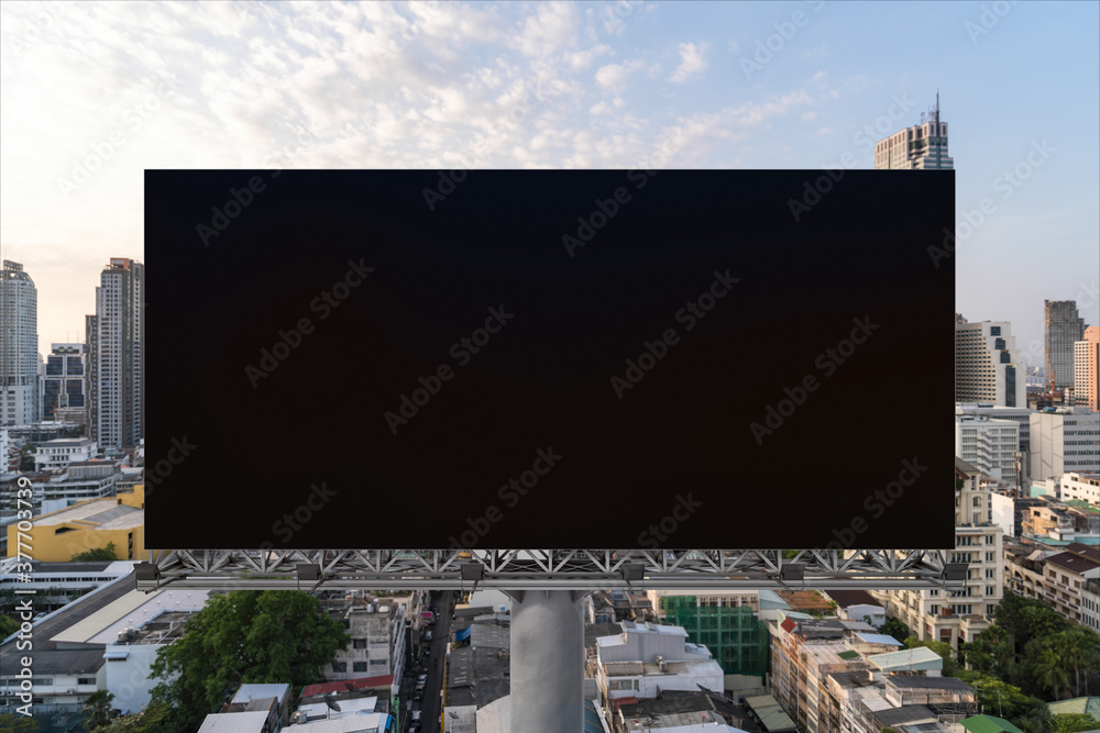 Obraz premium Blank black road billboard with Bangkok cityscape background at sunset. Street advertising poster, mock up, 3D rendering. Front view. The concept of marketing communication to promote or sell idea.