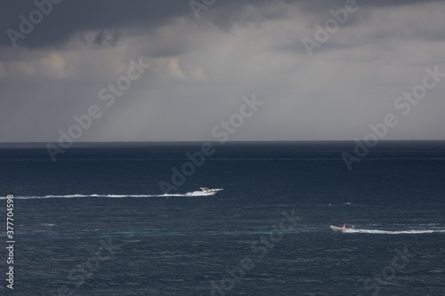 small boat at rough sea and windy weather, cloudy. © Lenti Hill