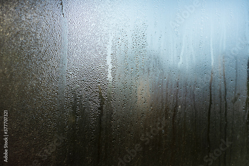  Misted window glass. Drops and trickles of water.