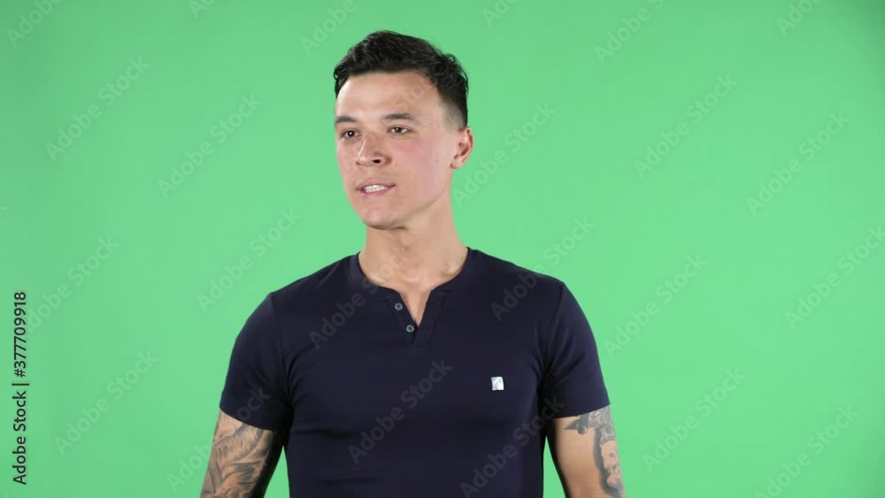 Portrait of handsome young guy is waiting for something going through and biting his fist. Green screen. Portrait of handsome young guy is waiting for something going through and biting his fist. Green screen.