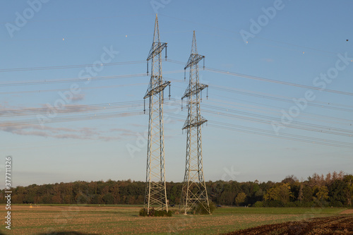 power pylon with power wires with blue sky as background