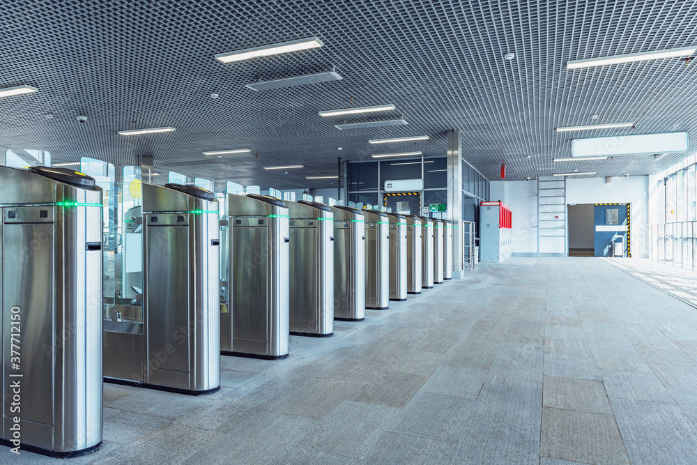 Turnstiles with electronic card readers on the station platform. Turnstiles with electronic card readers on the station platform.
