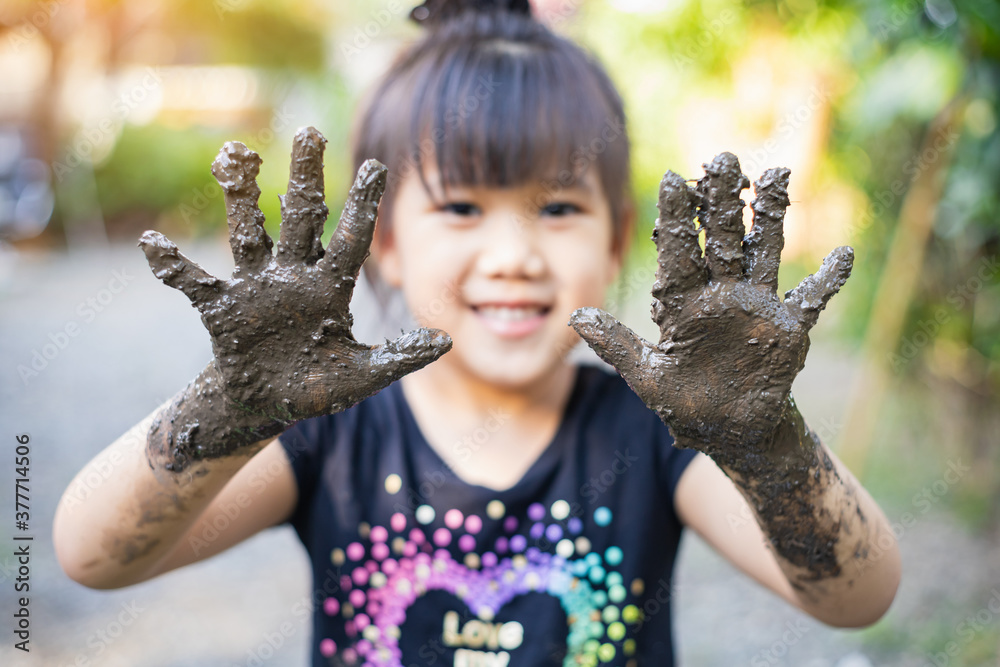 Kids playing with clay muddy. This activity is good for sensory experience and learning by touch their hands and fingers through clay and enjoying its texture. - obrazy, fototapety, plakaty 