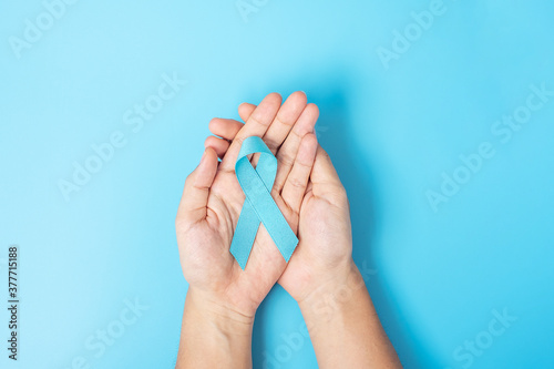 November Prostate Cancer Awareness month, Man holding light Blue Ribbon for supporting people living and illness. Healthcare, International men, Father, World cancer day and world diabetes day concept
