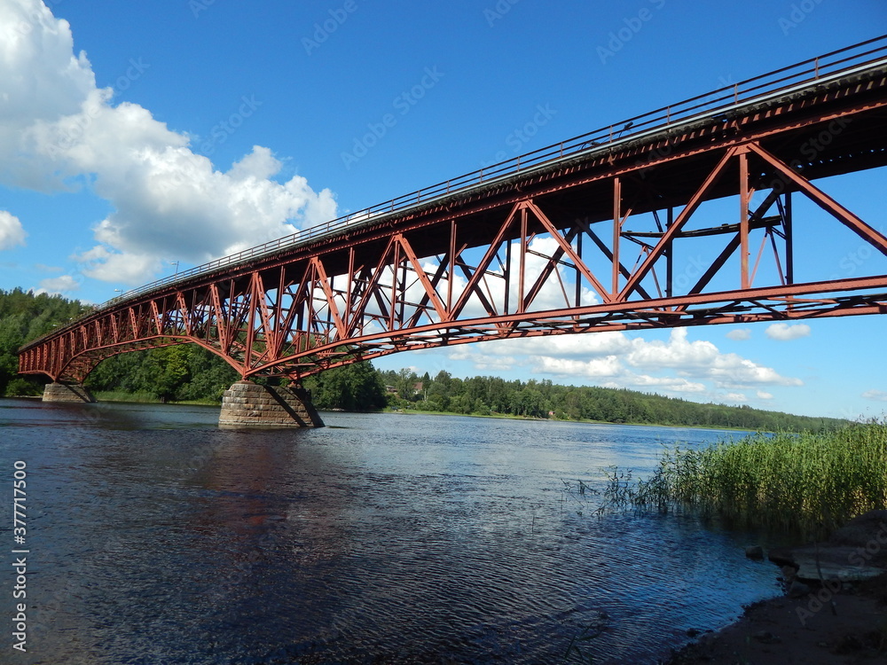 Summer landscape with old iron bridge and river