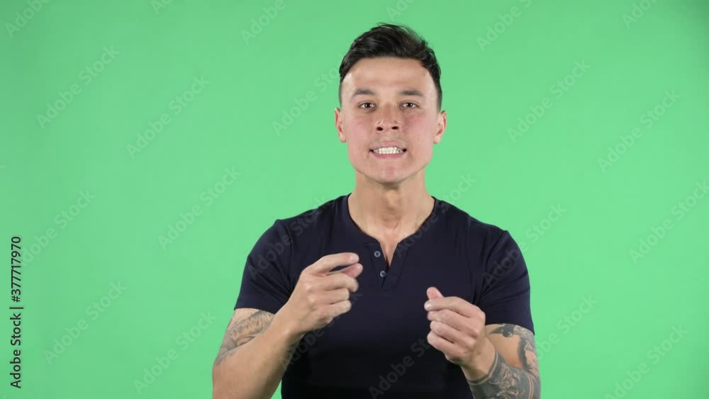 Portrait of a handsome young guy is looking at camera with anticipation and then very upset. Green screen. Portrait of a handsome young guy is looking at camera with anticipation and then very upset. Green screen.