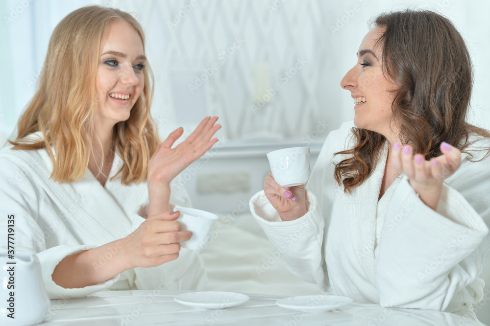 Close up portrait of women wearing a white bathrobes with magazine Close up portrait of women wearing a white bathrobes with magazine